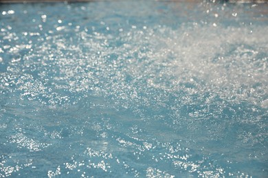 Photo of Splashes in swimming pool on sunny day. Summer vacation