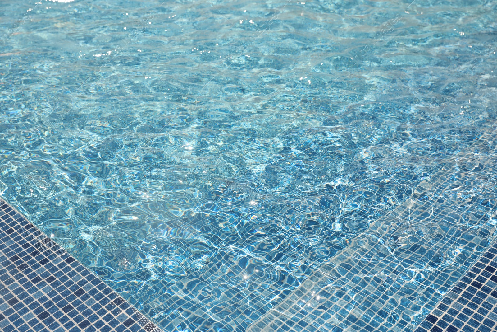 Swimming pool with clean blue water. Summer vacation Photo of Swimming pool with clean blue water. Summer vacation