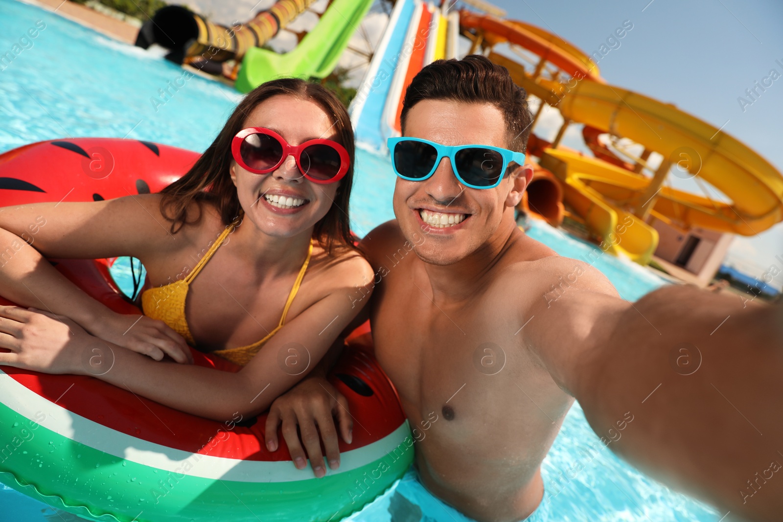 Happy couple taking selfie at water park. Summer vacation Photo of Happy couple taking selfie at water park. Summer vacation