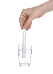 Photo of Woman examining water with nitrate tester on white background, closeup