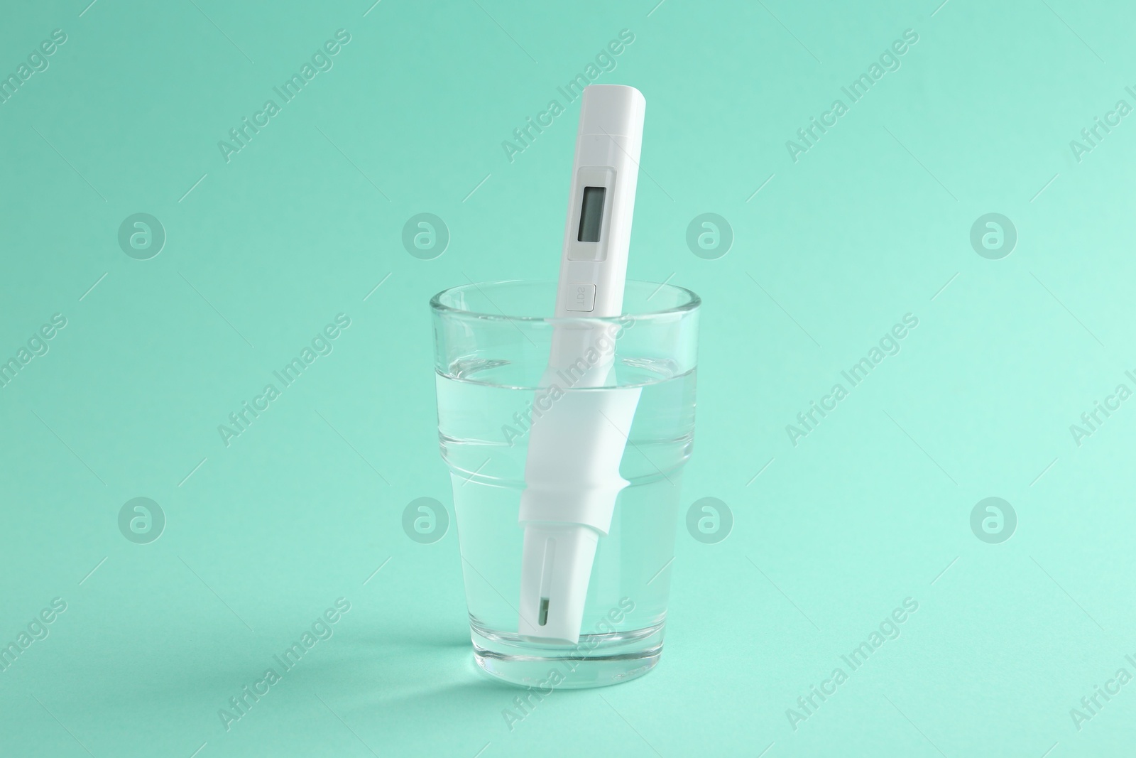 Nitrate tester in glass of water on turquoise background Photo of Nitrate tester in glass of water on turquoise background
