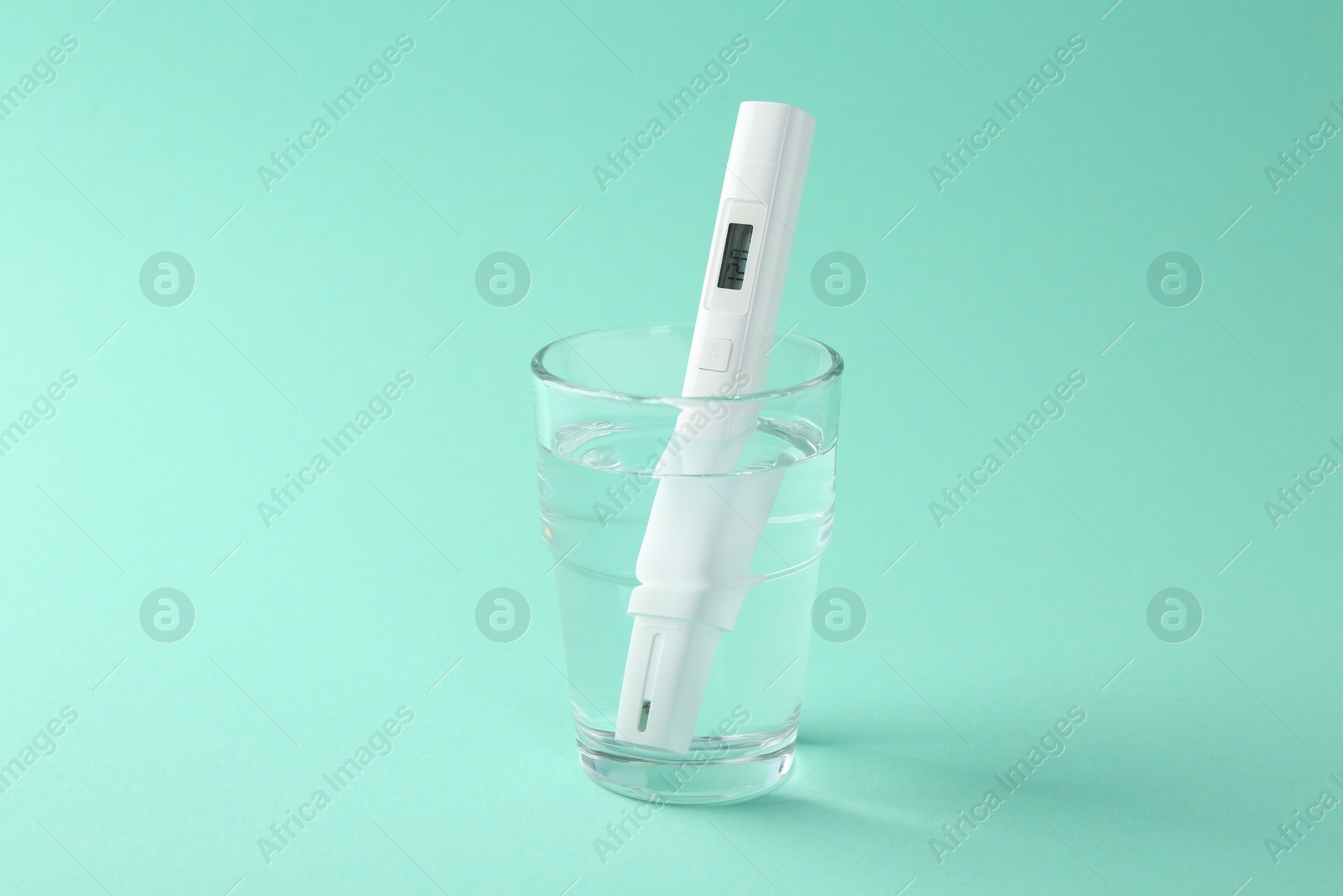 Nitrate tester in glass of water on turquoise background Photo of Nitrate tester in glass of water on turquoise background