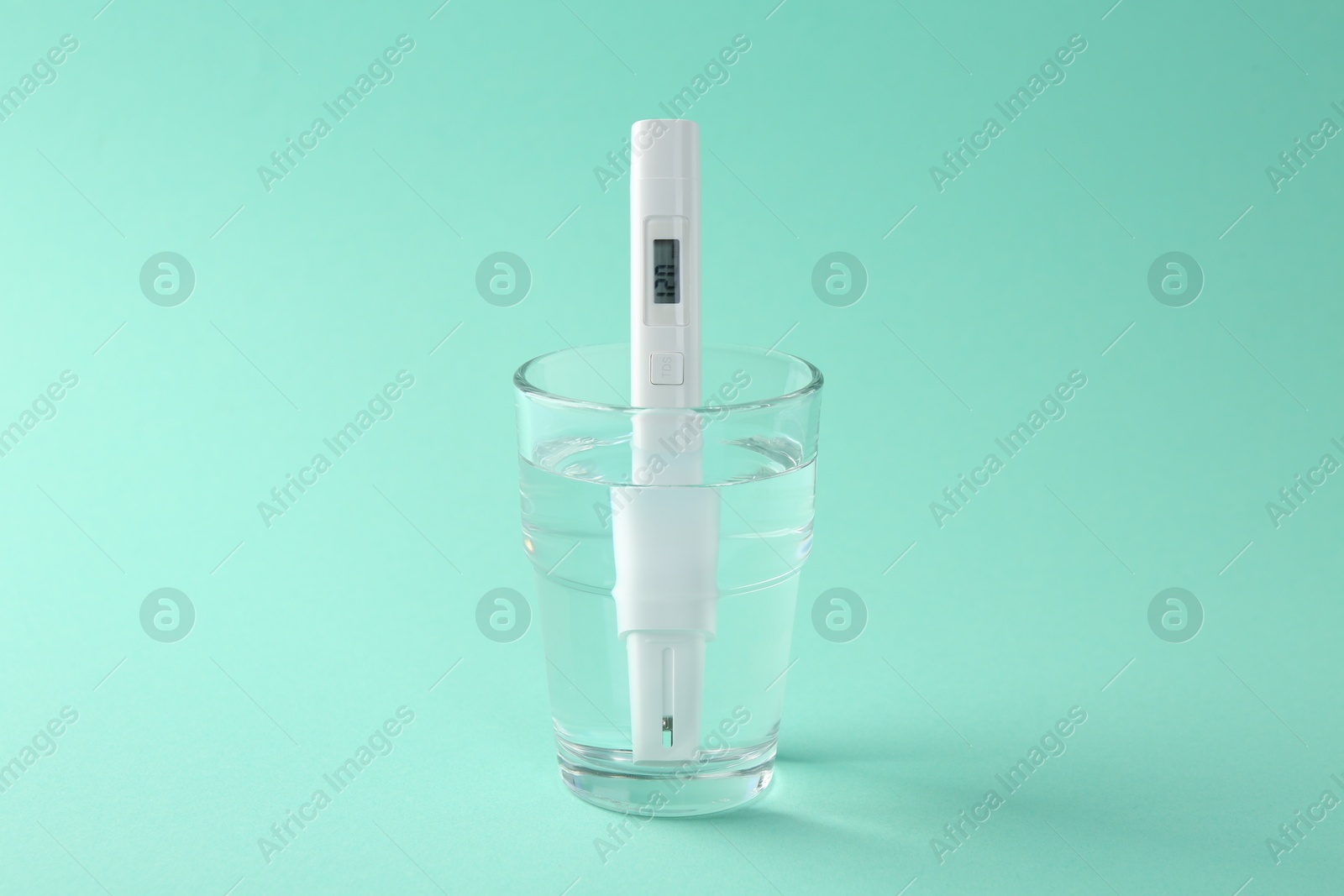 Nitrate tester in glass of water on turquoise background Photo of Nitrate tester in glass of water on turquoise background