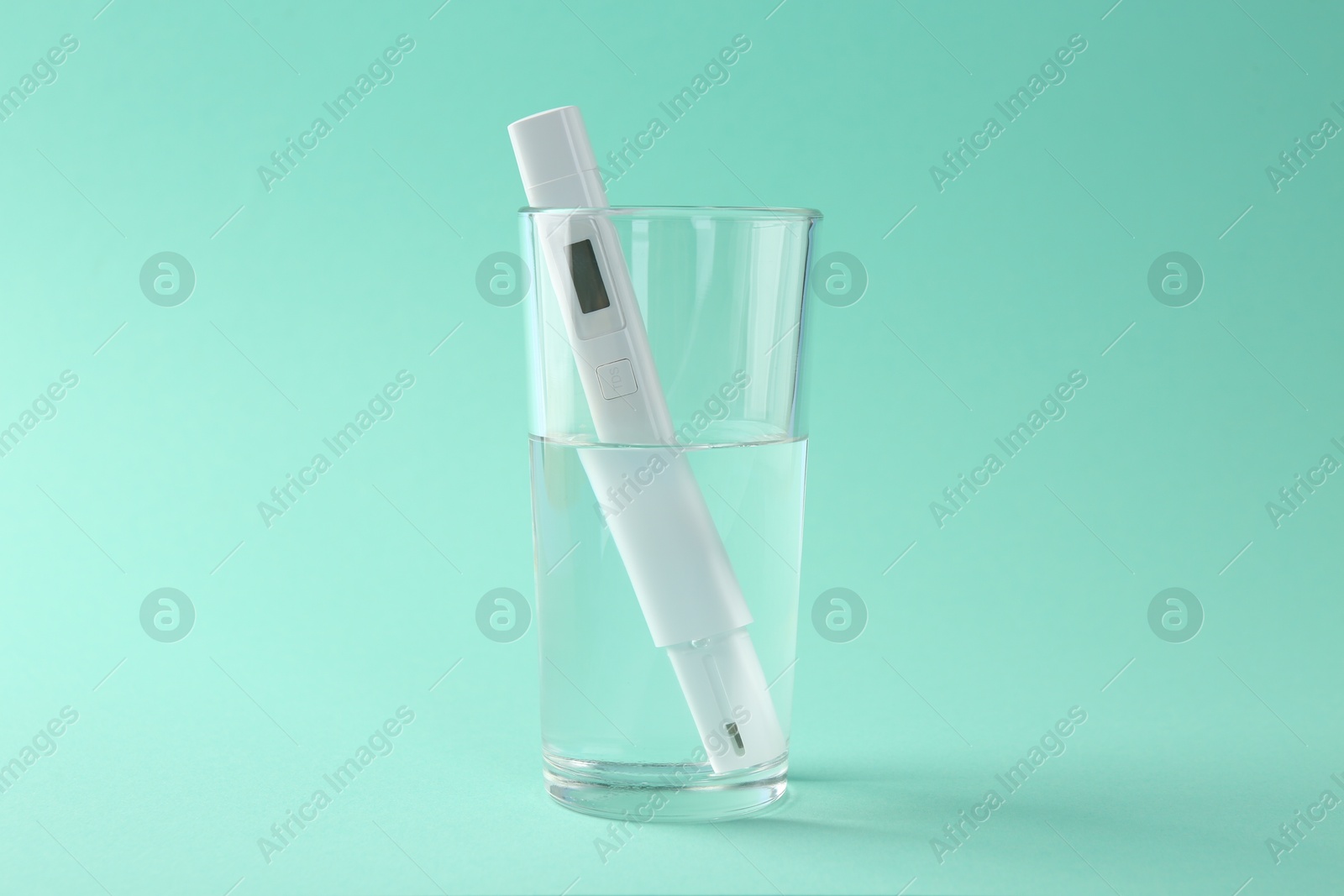 Nitrate tester in glass of water on turquoise background Photo of Nitrate tester in glass of water on turquoise background