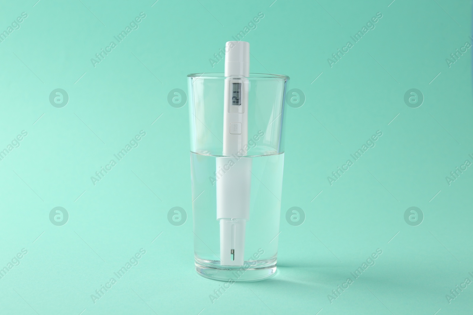 Nitrate tester in glass of water on turquoise background Photo of Nitrate tester in glass of water on turquoise background