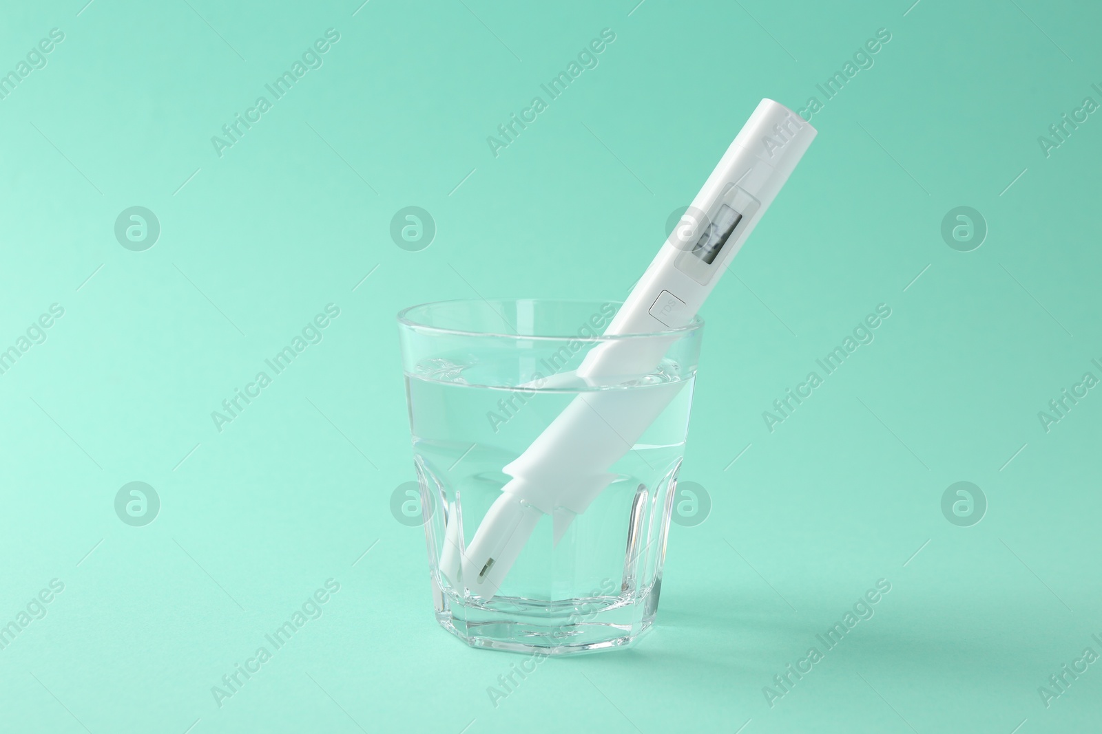 Nitrate tester in glass of water on turquoise background Photo of Nitrate tester in glass of water on turquoise background