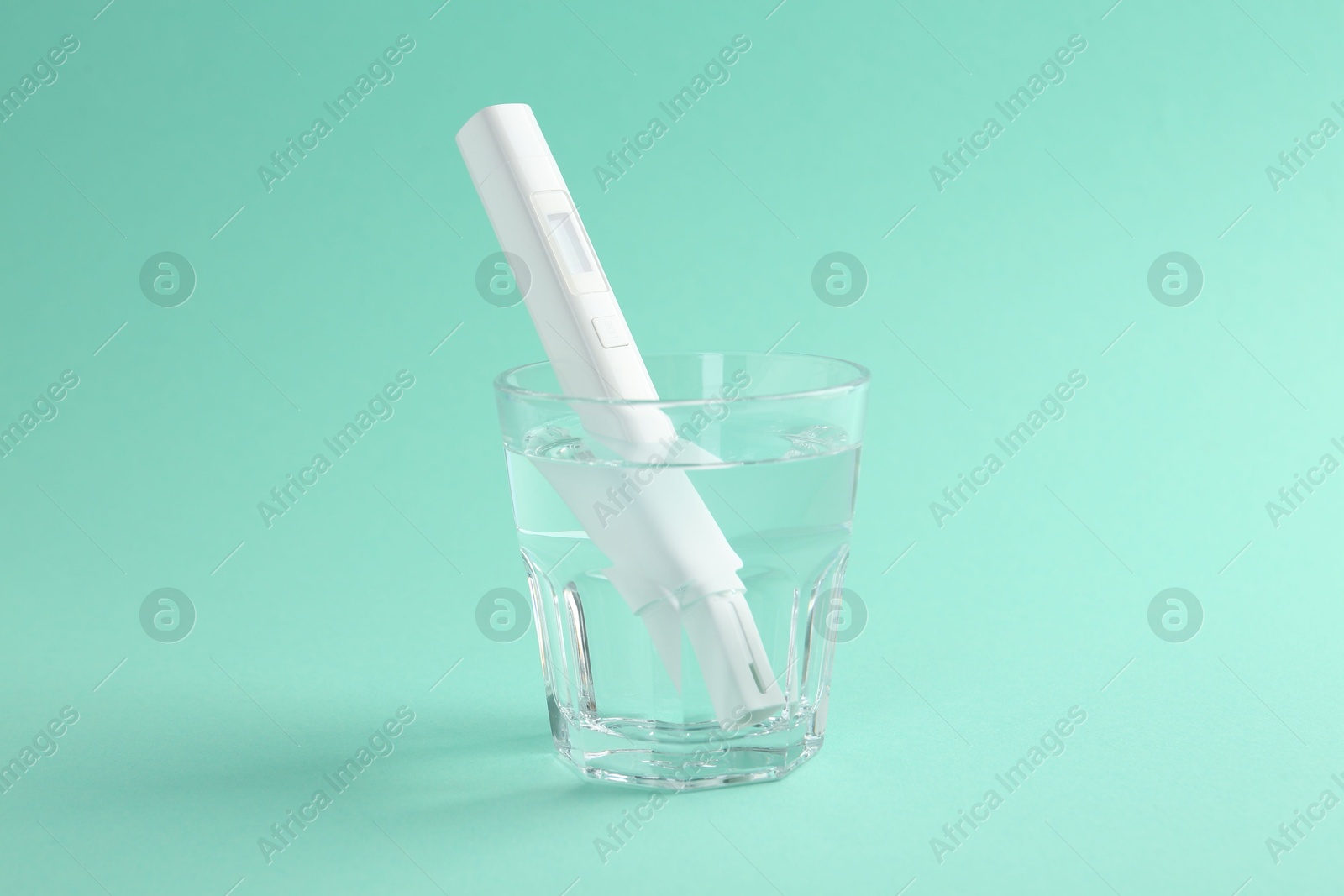 Nitrate tester in glass of water on turquoise background Photo of Nitrate tester in glass of water on turquoise background