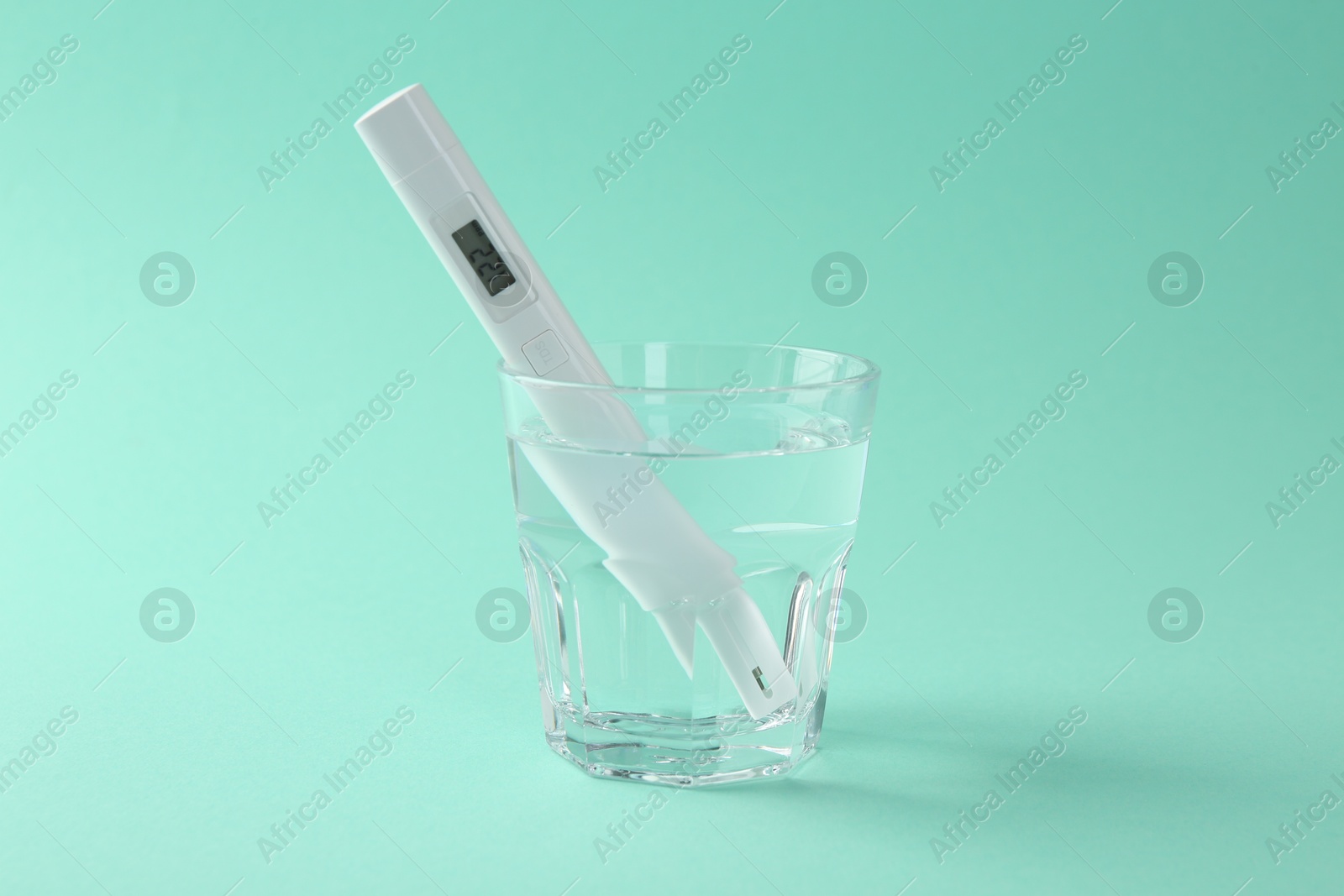 Nitrate tester in glass of water on turquoise background Photo of Nitrate tester in glass of water on turquoise background