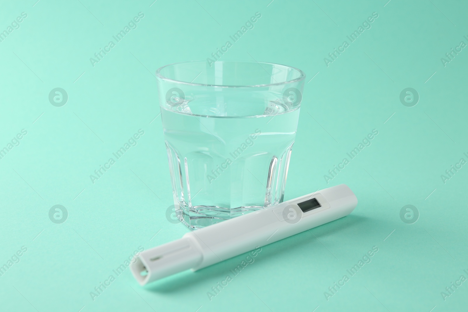 Nitrate tester and glass of water on turquoise background, closeup Photo of Nitrate tester and glass of water on turquoise background, closeup