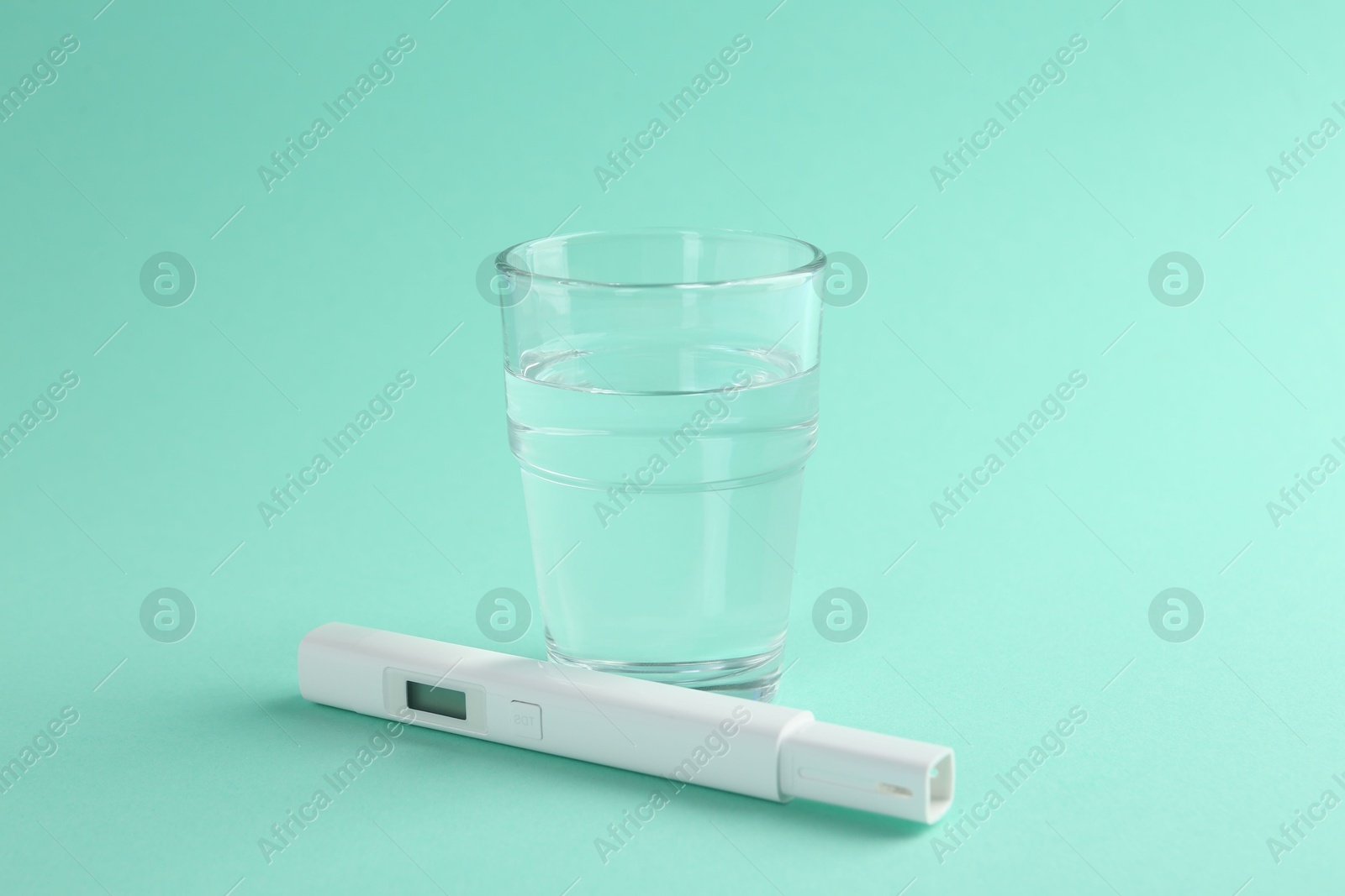 Nitrate tester and glass of water on turquoise background, closeup Photo of Nitrate tester and glass of water on turquoise background, closeup