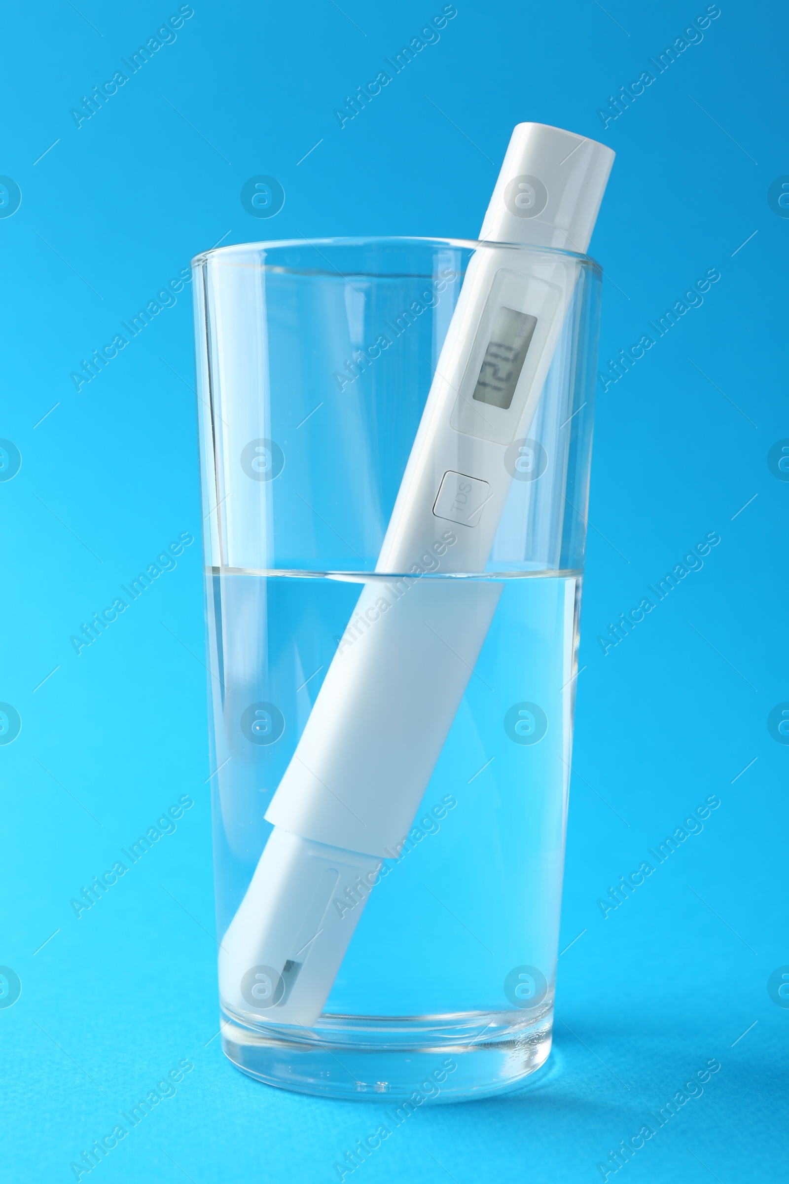 Nitrate tester in glass of water on light blue background, closeup Photo of Nitrate tester in glass of water on light blue background, closeup