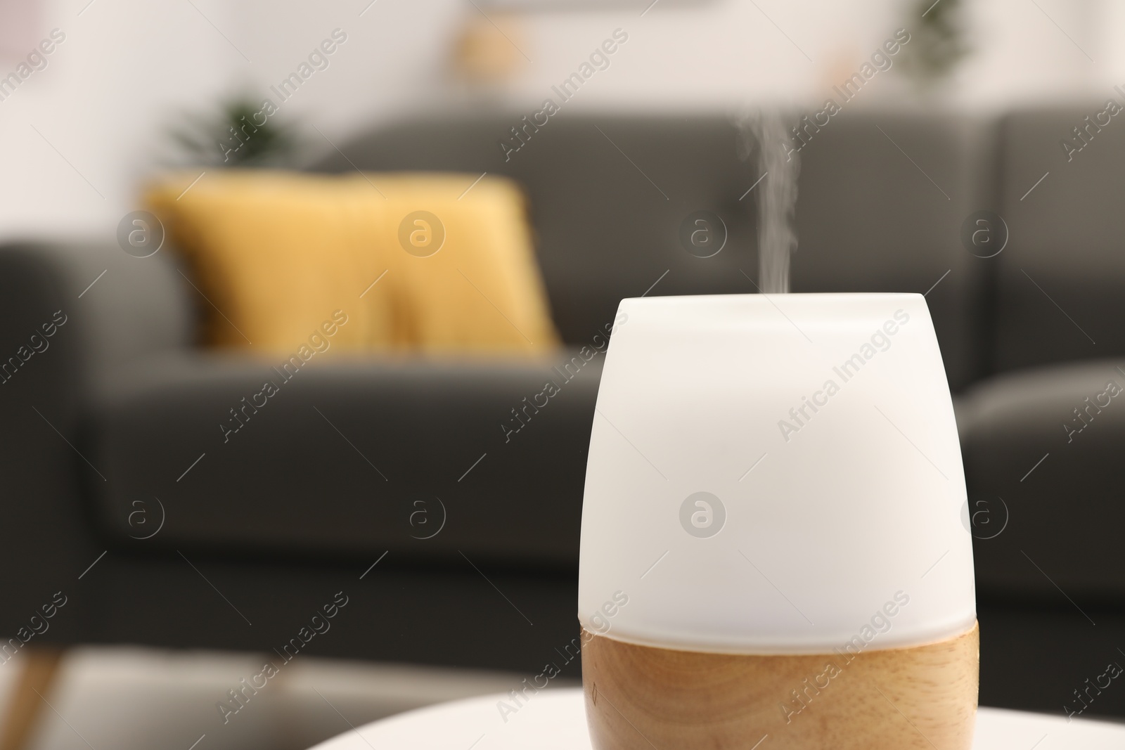 Modern aroma lamp on table indoors, closeup. Space for text Photo of Modern aroma lamp on table indoors, closeup. Space for text