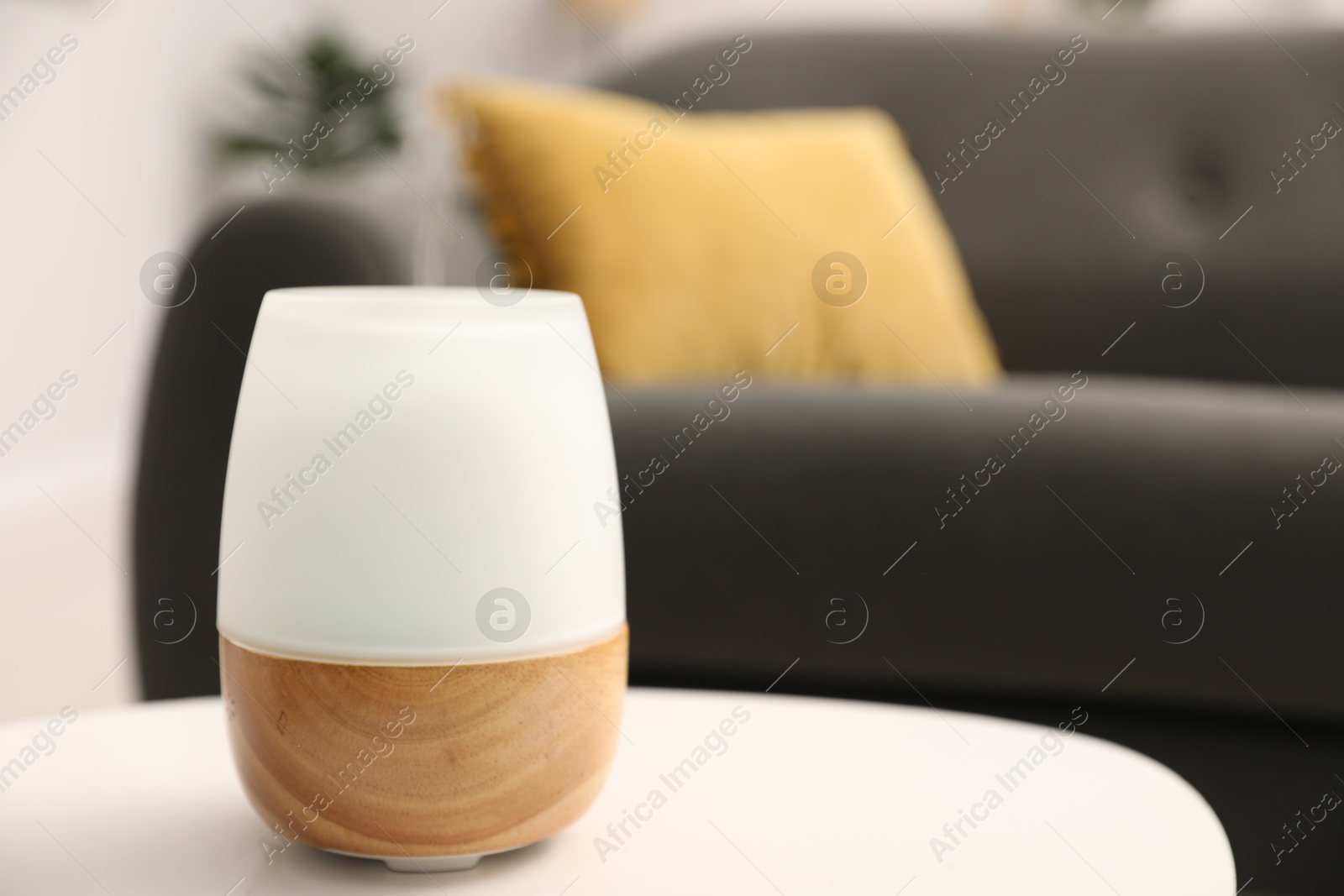 Modern aroma lamp on white table indoors. Space for text Photo of Modern aroma lamp on white table indoors. Space for text