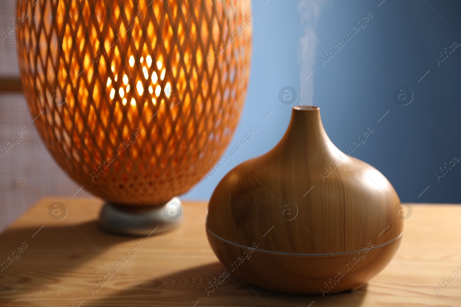 Modern aroma lamp on wooden table indoors, closeup Photo of Modern aroma lamp on wooden table indoors, closeup