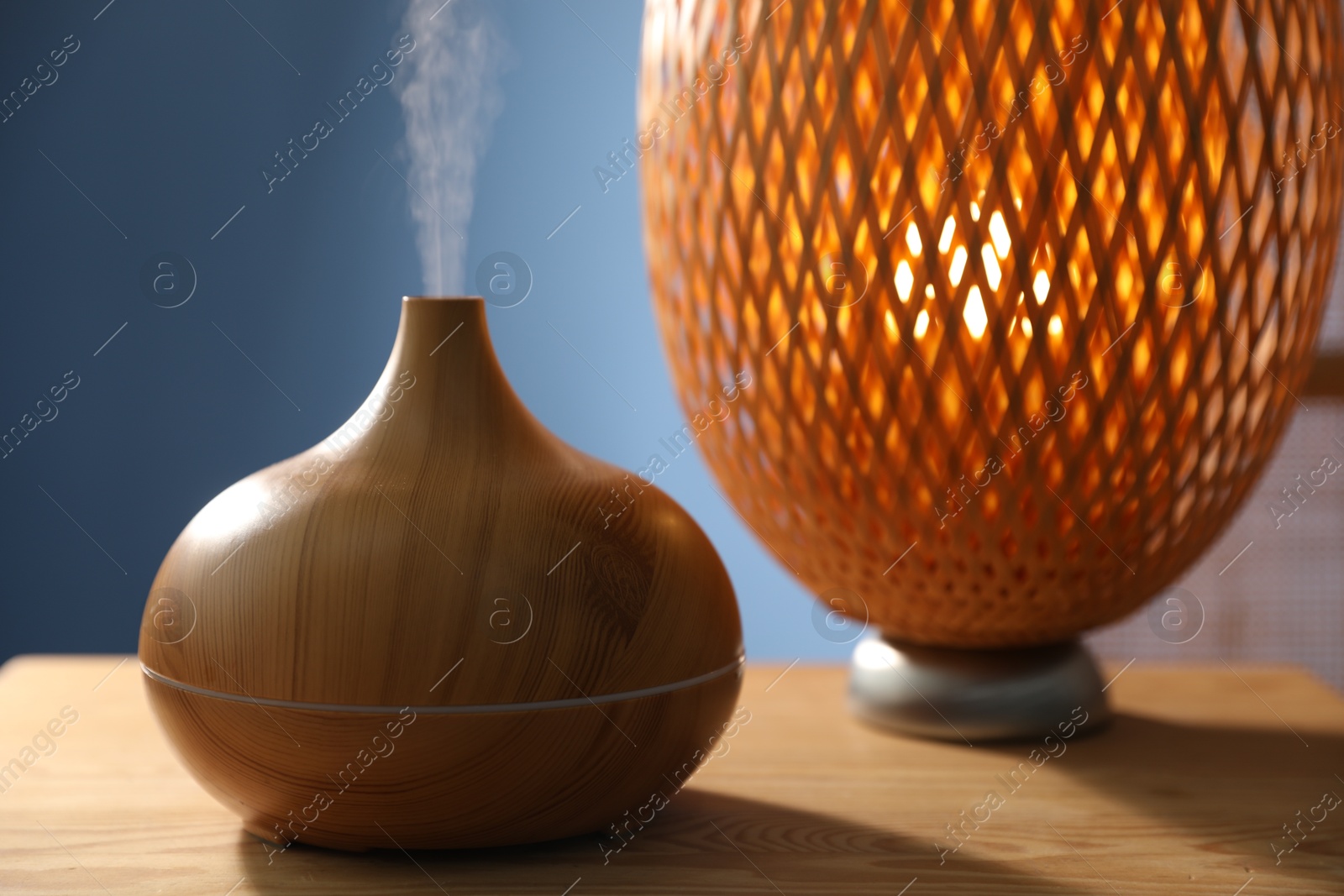 Modern aroma lamp on wooden table indoors, closeup Photo of Modern aroma lamp on wooden table indoors, closeup
