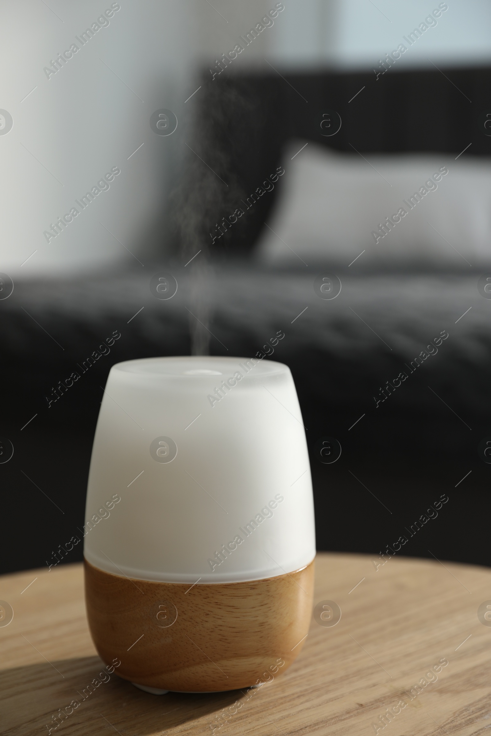 Modern aroma lamp on wooden table indoors, closeup Photo of Modern aroma lamp on wooden table indoors, closeup