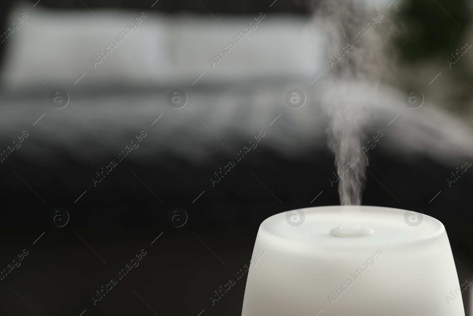 Modern aroma lamp against blurred background, closeup. Space for text Photo of Modern aroma lamp against blurred background, closeup. Space for text