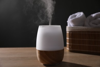 Photo of Modern aroma lamp on wooden table indoors