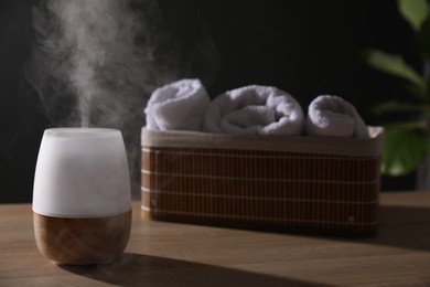 Photo of Modern aroma lamp on wooden table indoors
