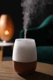 Photo of Modern aroma lamp on wooden table indoors