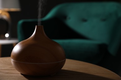 Photo of Modern aroma lamp on wooden table indoors, closeup