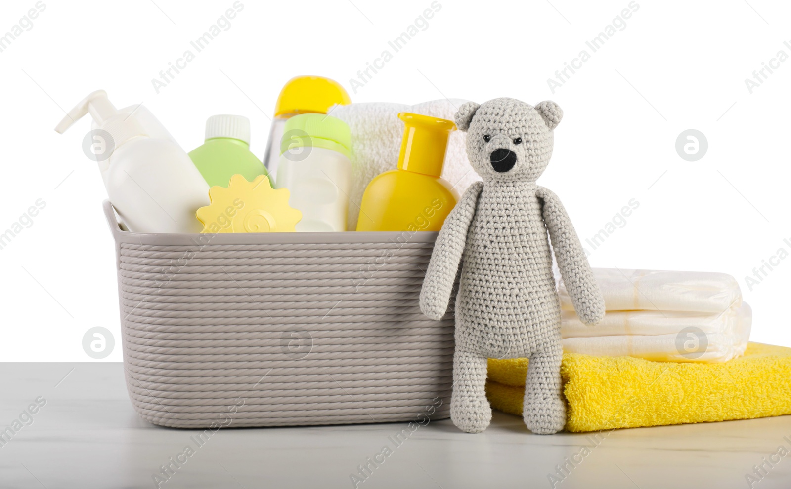 Photo of Different baby accessories and toy bear on table against white background