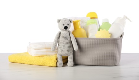 Photo of Different baby accessories and toy bear on table against white background