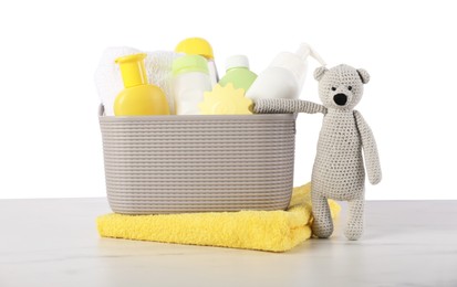 Photo of Different baby accessories and toy bear on table against white background
