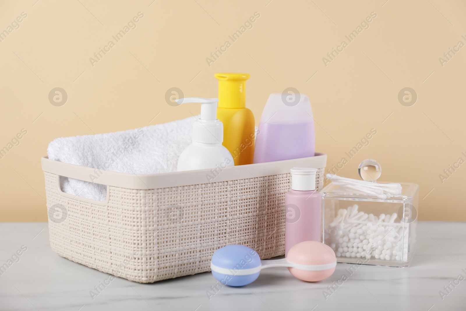 Photo of Different baby accessories on table against beige background