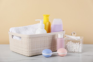 Photo of Different baby accessories on table against beige background