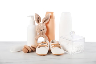 Photo of Different baby accessories and toys on table against white background