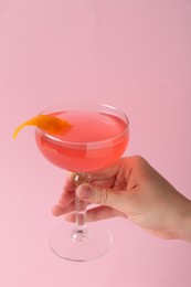 Photo of Woman with martini cocktail on pink background, closeup