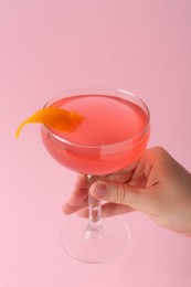 Photo of Woman with martini cocktail on pink background, closeup