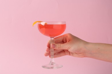Photo of Woman with martini cocktail on pink background, closeup