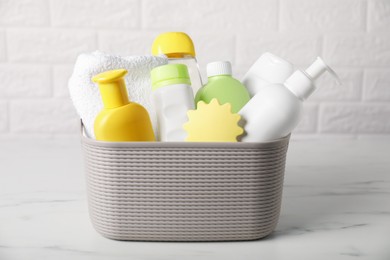 Photo of Many different baby bathroom necessities on table near brick wall