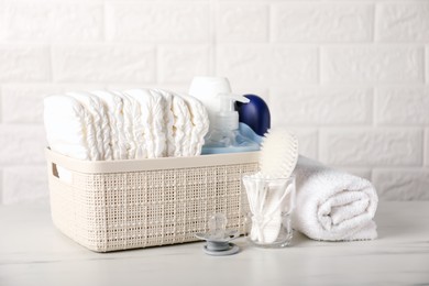 Photo of Many different baby accessories on table near brick wall