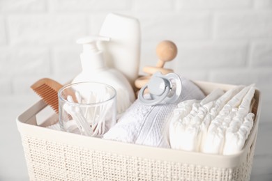 Photo of Many different baby accessories on table near brick wall, closeup