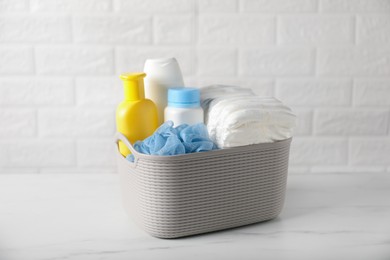 Photo of Many different baby bathroom necessities on table near brick wall