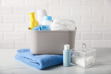 Photo of Many different baby bathroom necessities on table near brick wall