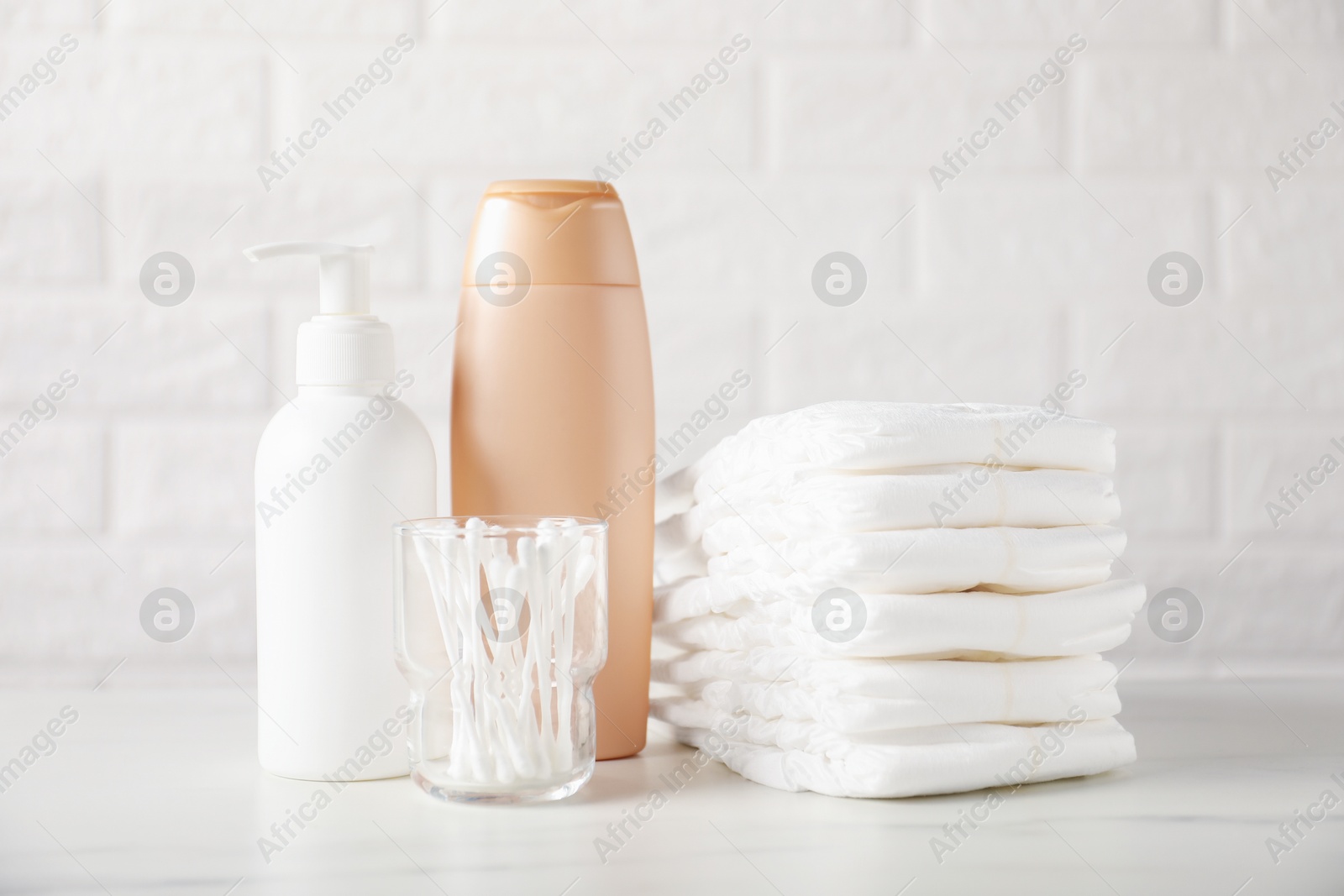 Photo of Many different baby accessories on table near brick wall