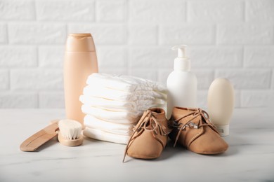 Photo of Many different baby accessories on table near brick wall