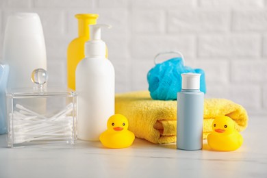 Photo of Many different baby bathroom necessities on table near brick wall