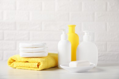 Photo of Many different baby accessories on table near brick wall