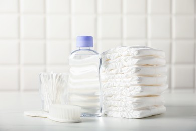 Photo of Many different baby accessories on table near tiled wall