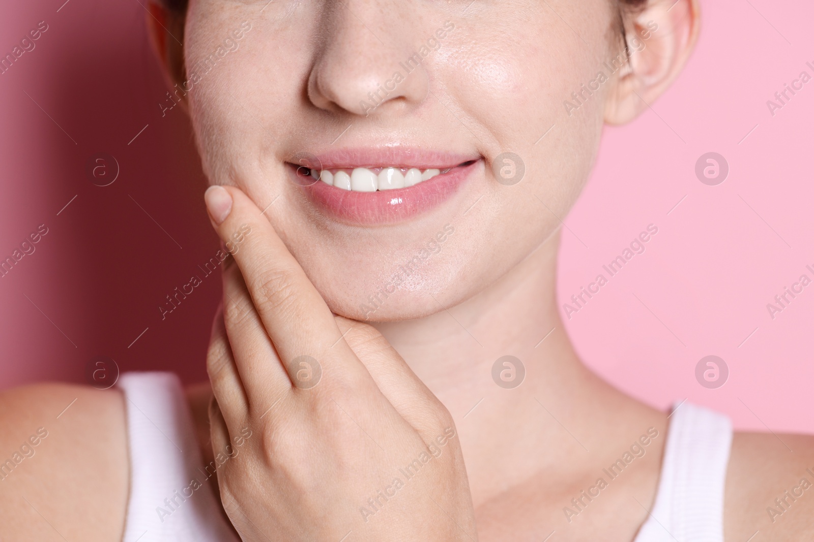 Smiling woman after dental aligners treatment on pink background, closeup Photo of Smiling woman after dental aligners treatment on pink background, closeup