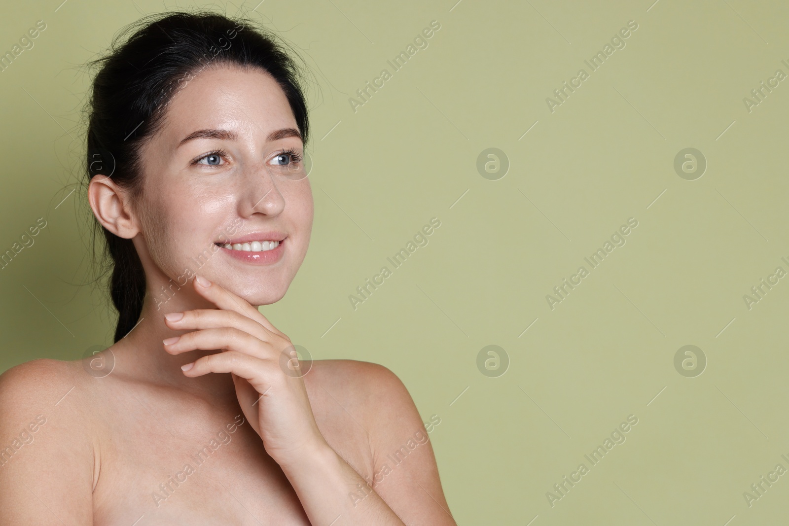 Smiling woman after dental aligners treatment on green background. Space for text Photo of Smiling woman after dental aligners treatment on green background. Space for text
