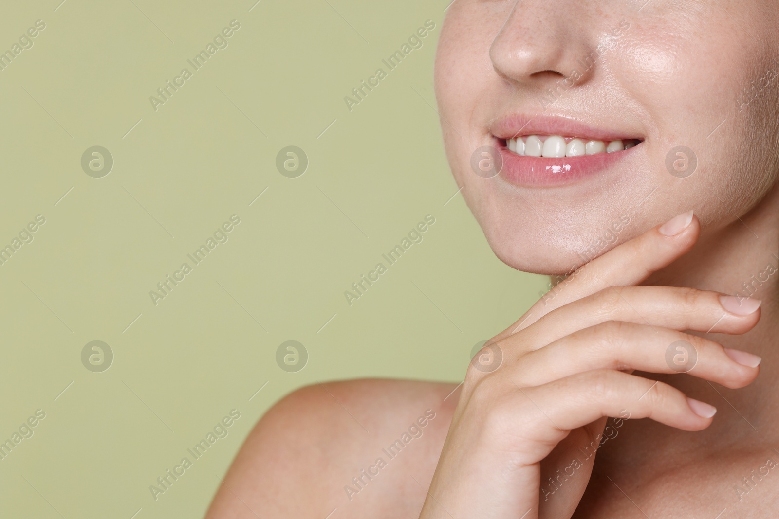Smiling woman after dental aligners treatment on green background, closeup. Space for text Photo of Smiling woman after dental aligners treatment on green background, closeup. Space for text