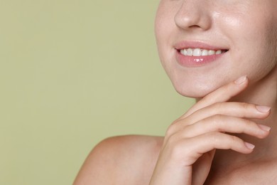 Photo of Smiling woman after dental aligners treatment on green background, closeup. Space for text