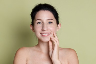 Photo of Portrait of smiling woman after dental aligners treatment on green background