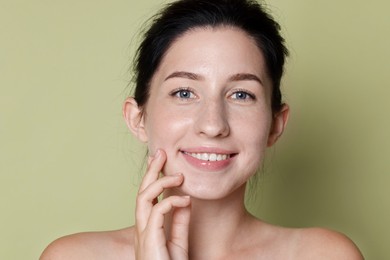 Photo of Portrait of smiling woman after dental aligners treatment on green background, closeup
